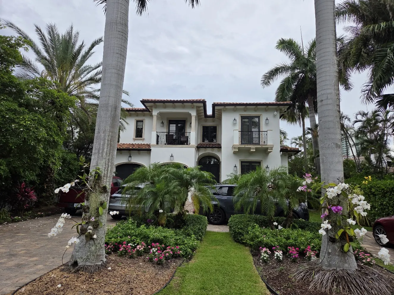Two-story Mediterranean residence among palms after an exterior repaint