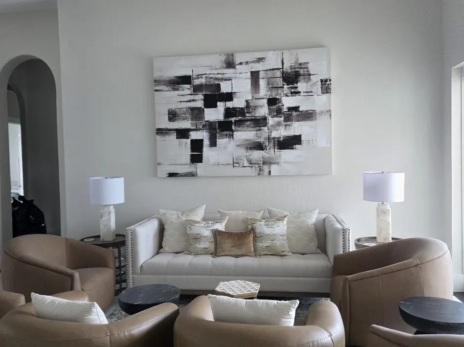 Condominium living room with leather armchairs after interior painting