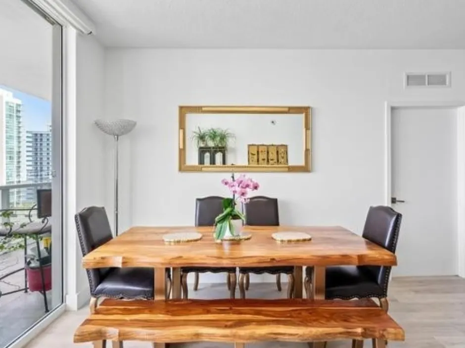 Condominium dining area with balcony beyond after interior painting