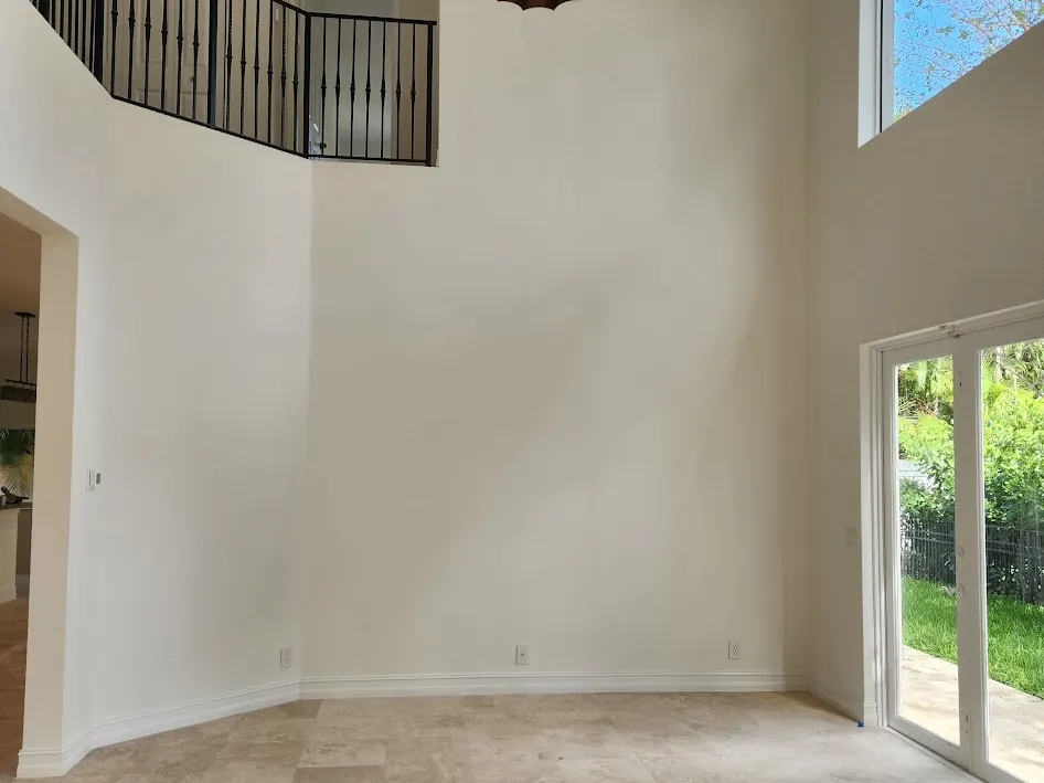 Double-height living room with white walls after interior painting