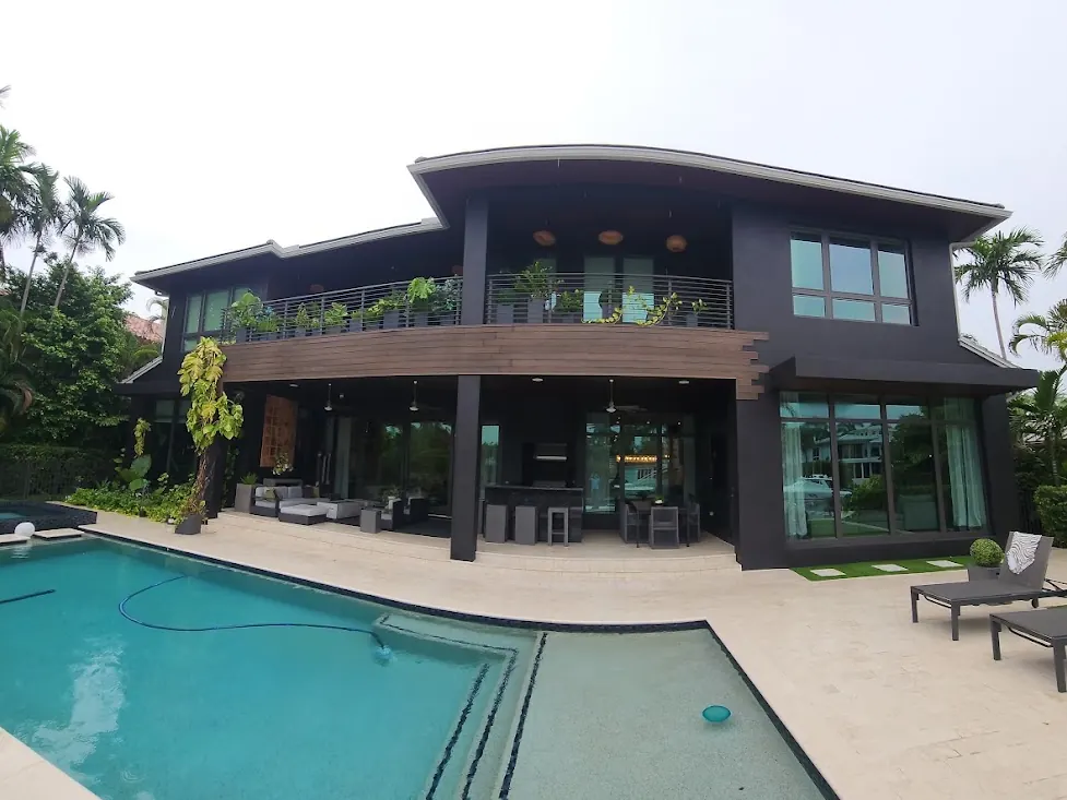 Dark contemporary two-story home with a pool terrace in Fort Lauderdale after an exterior repaint