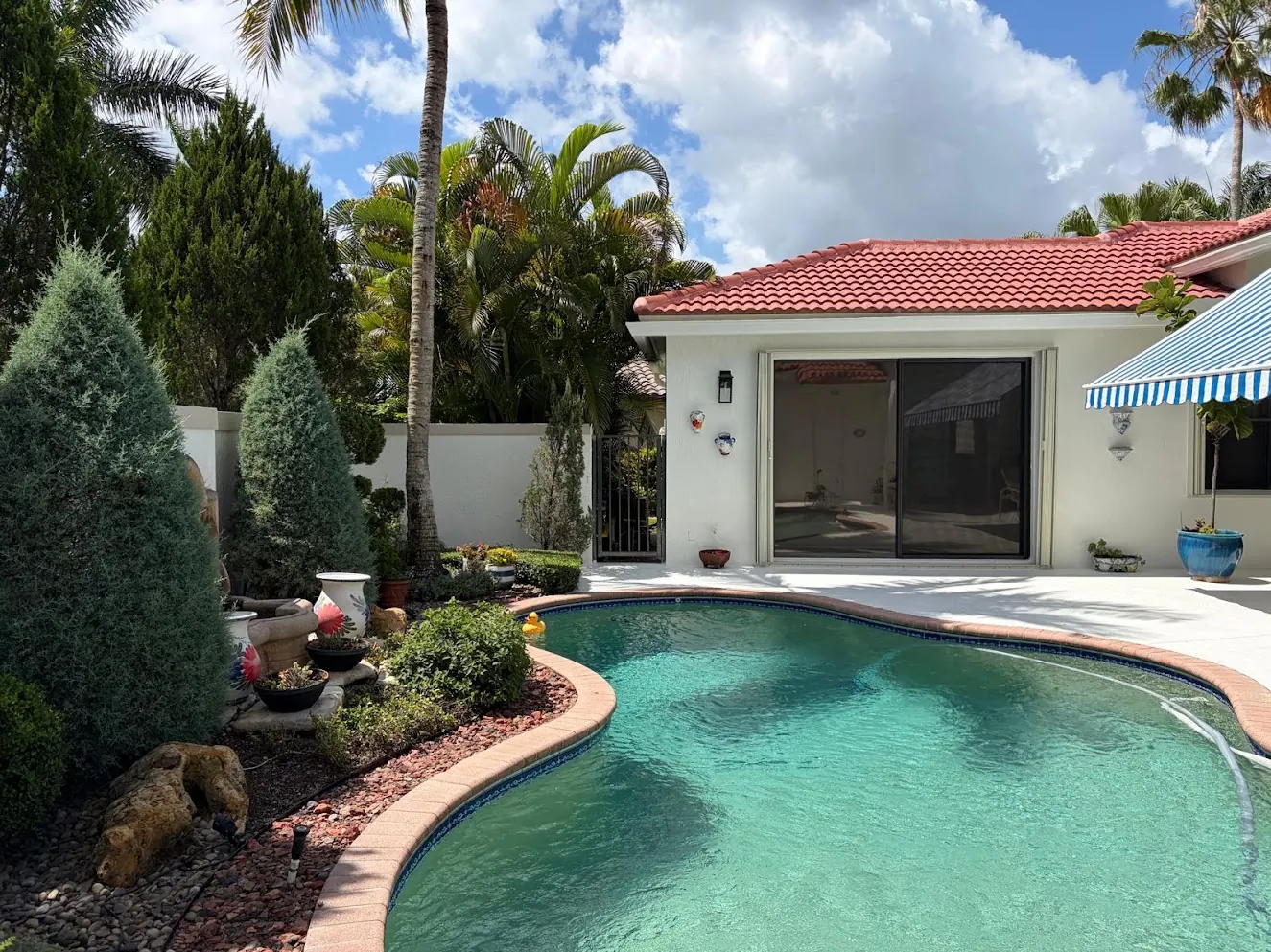 Pool patio and white home exterior in Weston after repainting