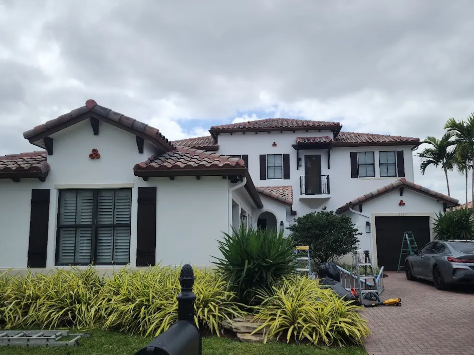 Spanish-style Weston home with black shutters after an exterior repaint