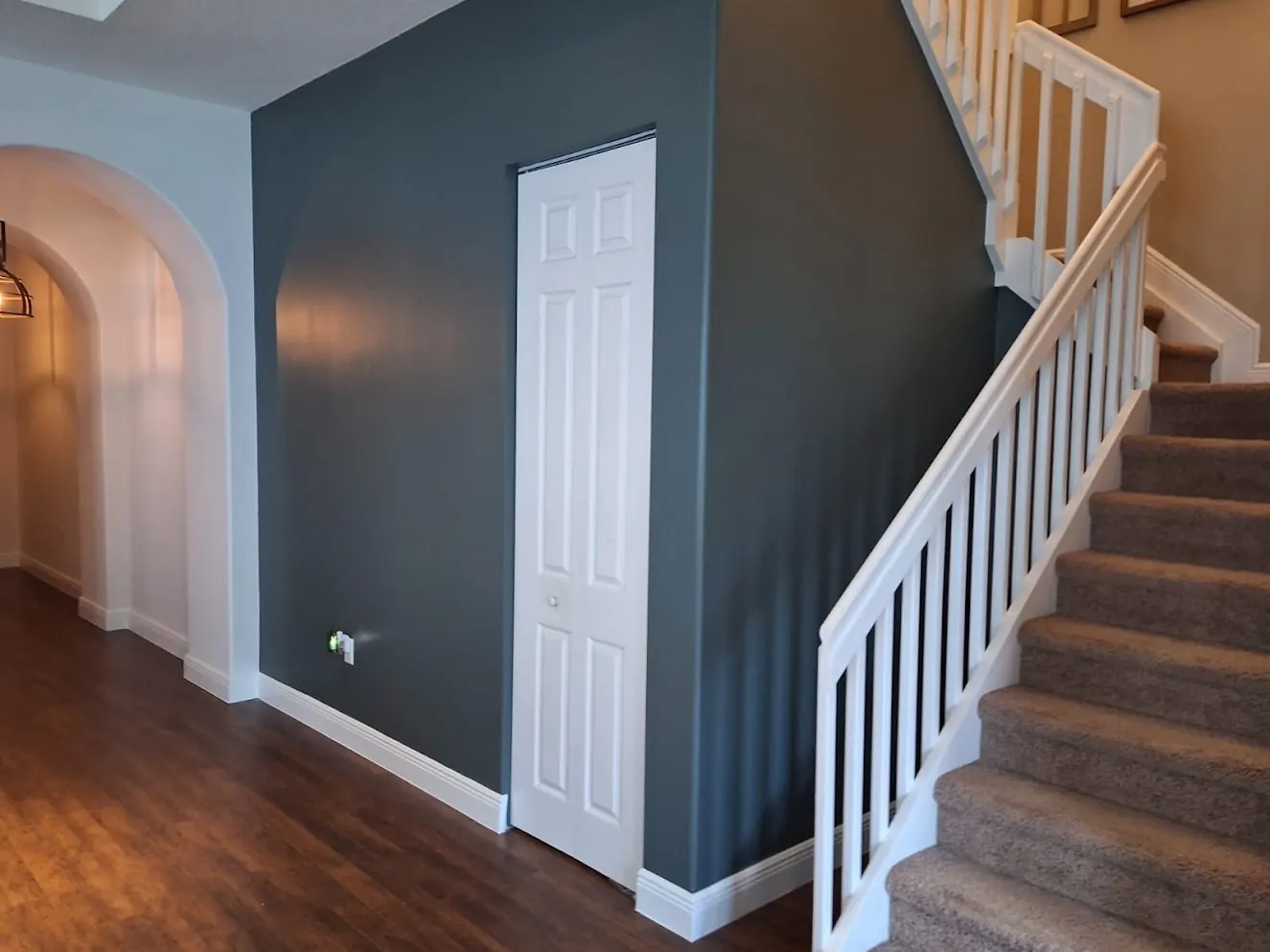 Stair hall with a dark accent wall after interior painting
