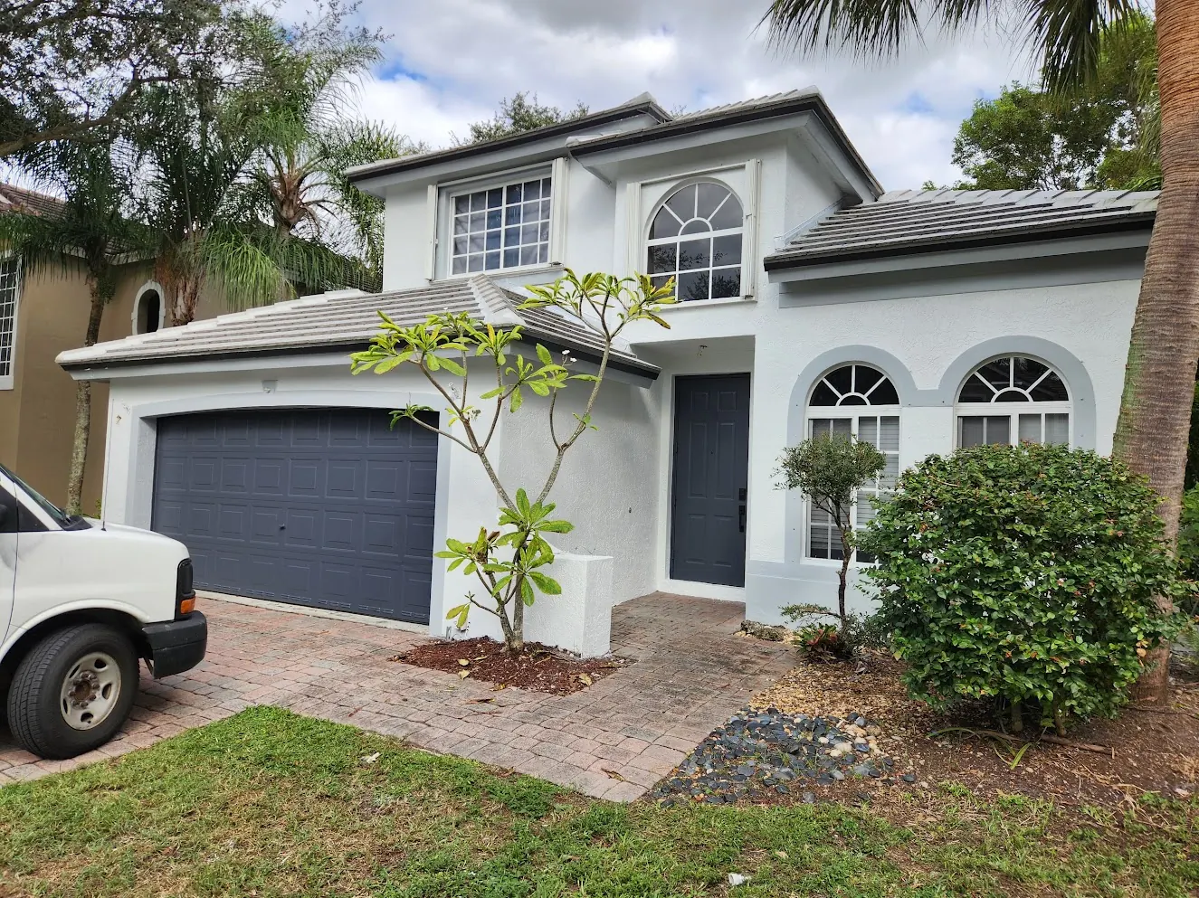 Two-story Weston home with a grey garage door after an exterior repaint