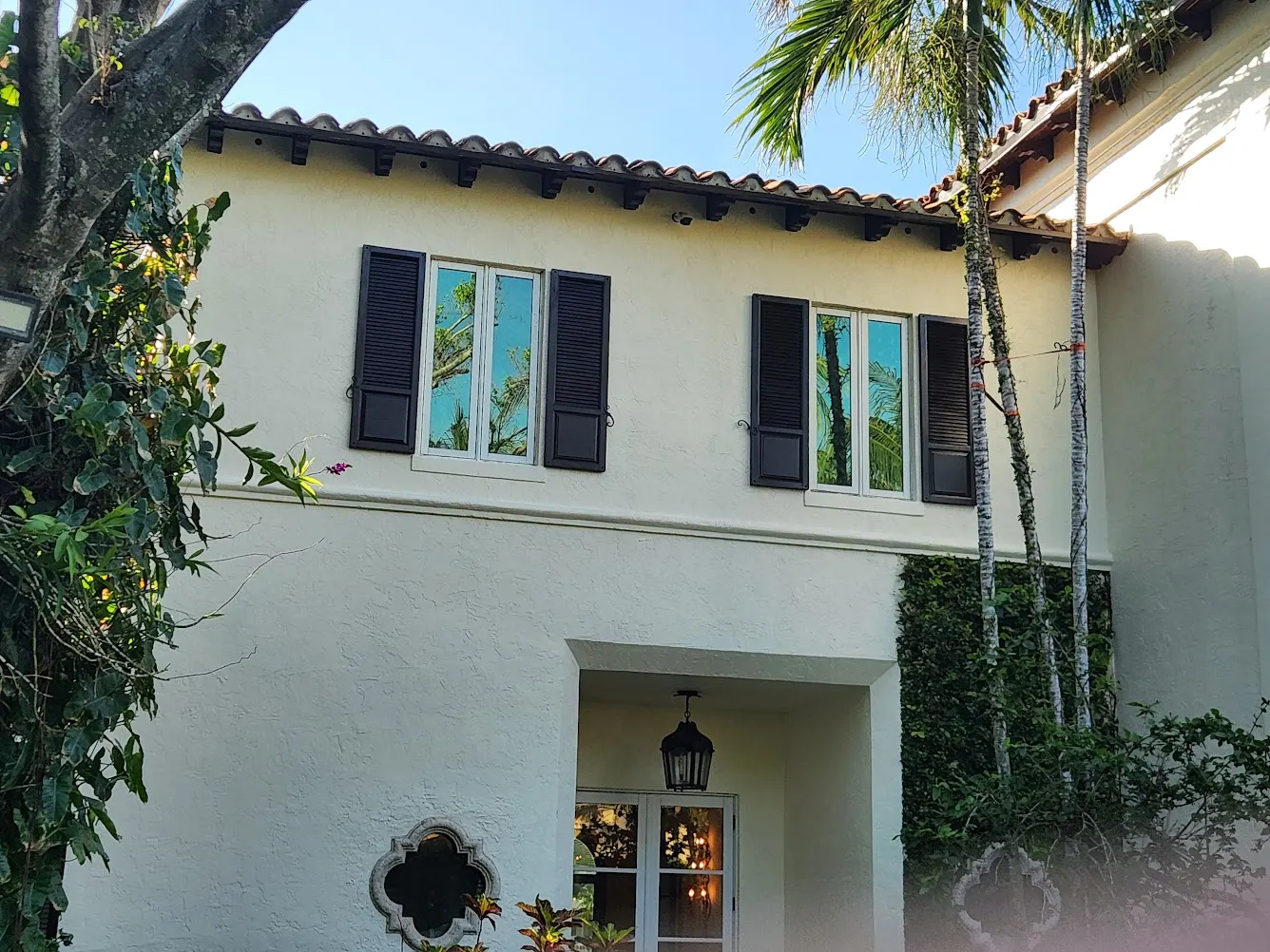 Restored cream stucco facade of the Golden Beach estate