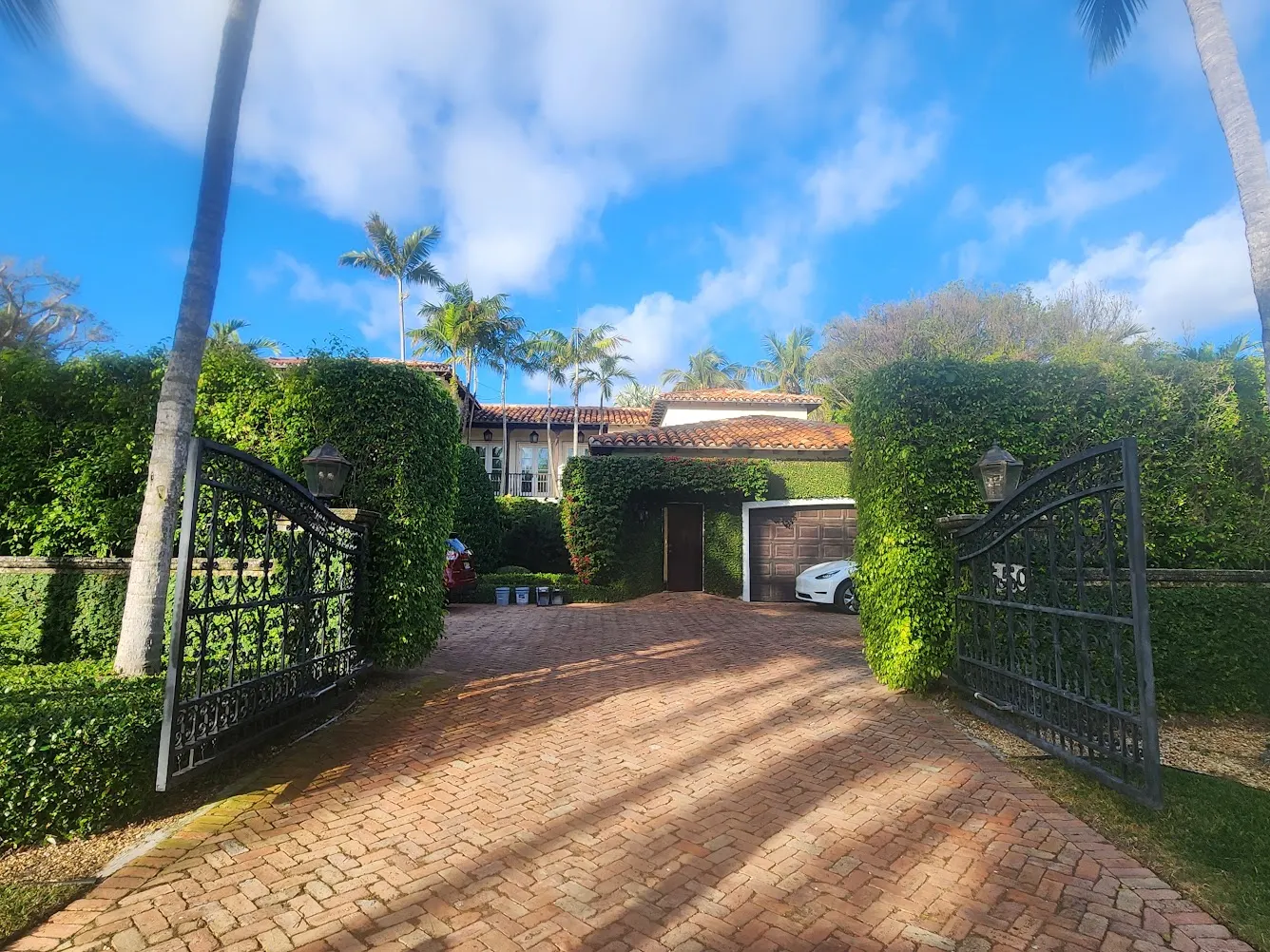 Iron entrance gates and brick driveway of the estate