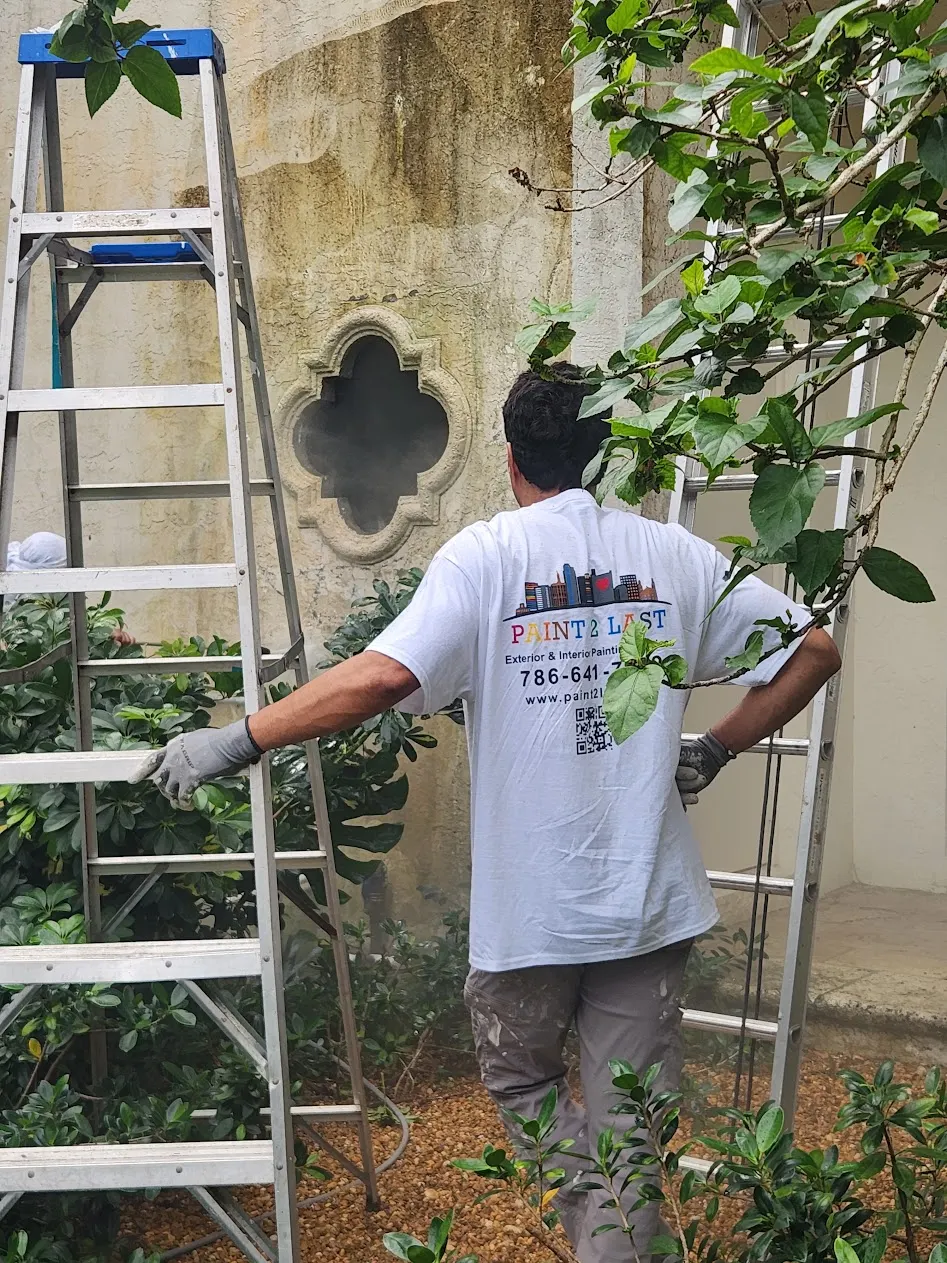 Paint2Last crew preparing the masonry around a quatrefoil window