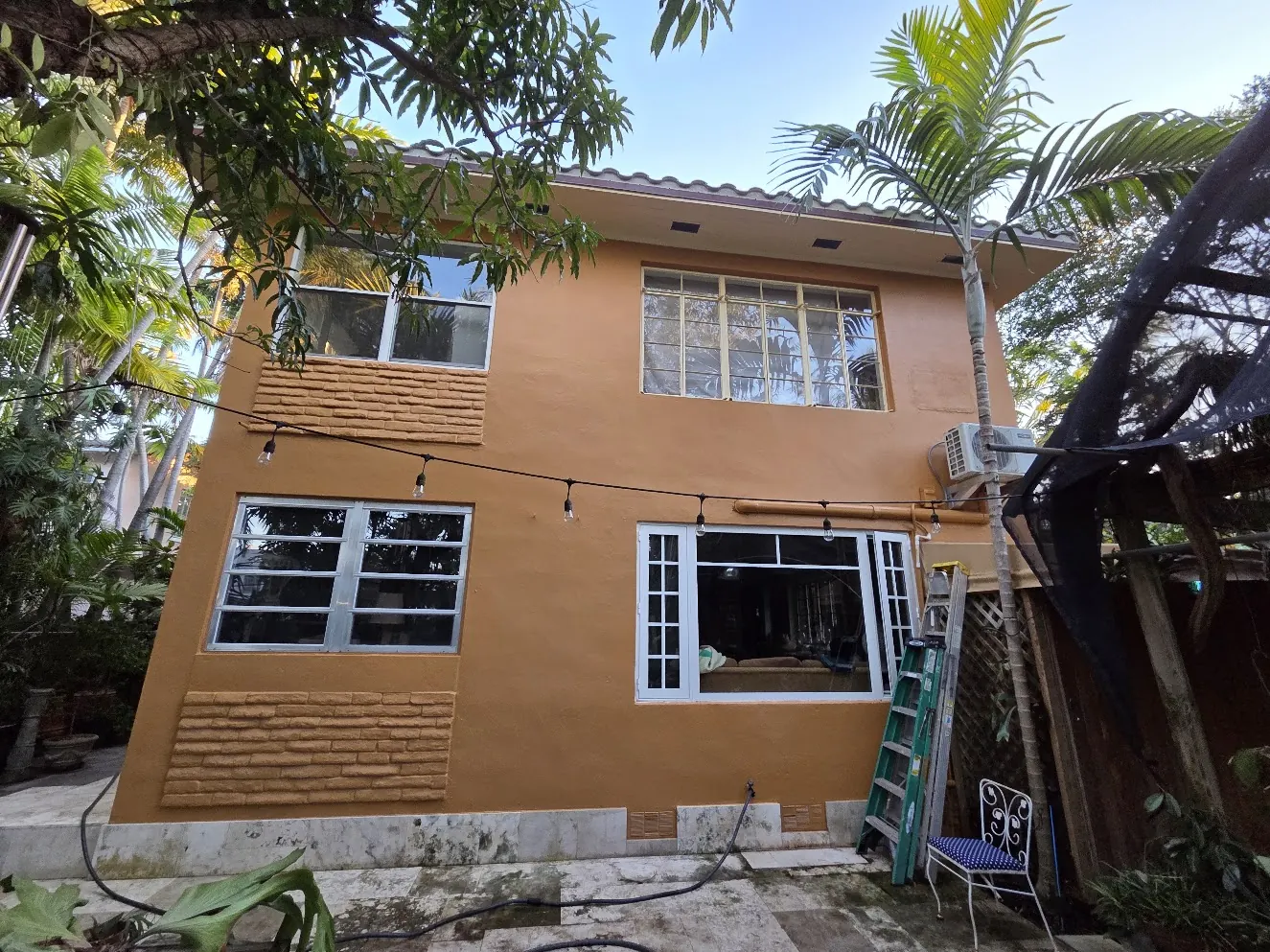 Garden elevation after restoration with repaired stucco and repainted metal windows