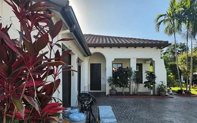 Is it better to roll or spray exterior house paint?